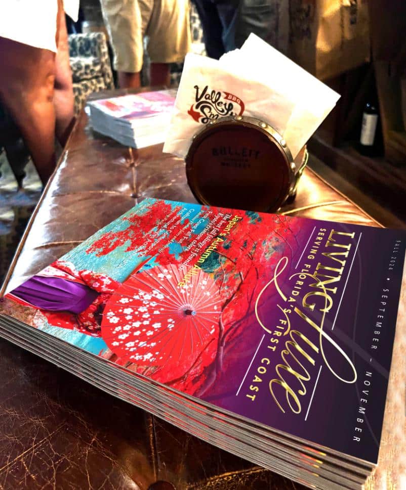 Living Luxe Magazine displayed at a fine dining location